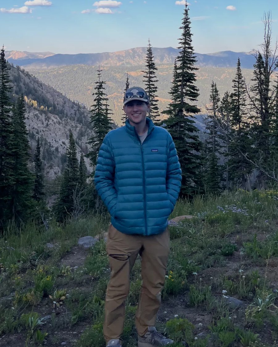 Eli Krasnoff standing on a mountain trail